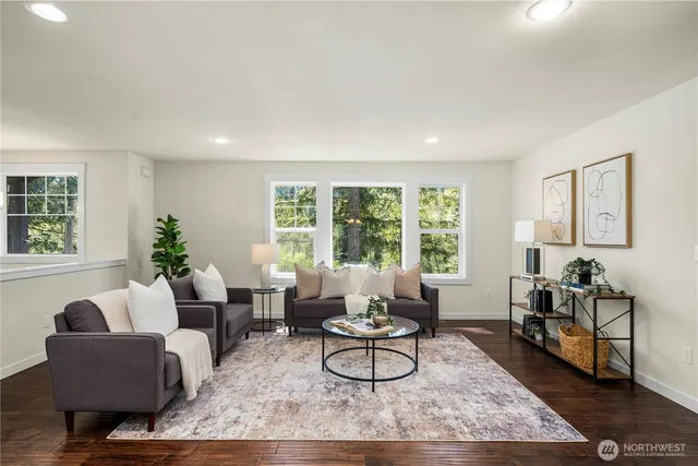a living room with furniture and wooden floor