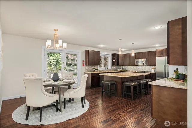 a dining room with furniture a rug and wooden floor