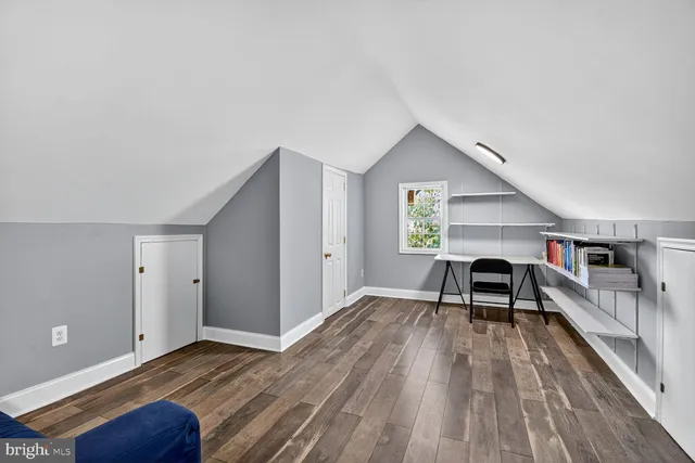 a view of a bedroom with furniture and wooden floor