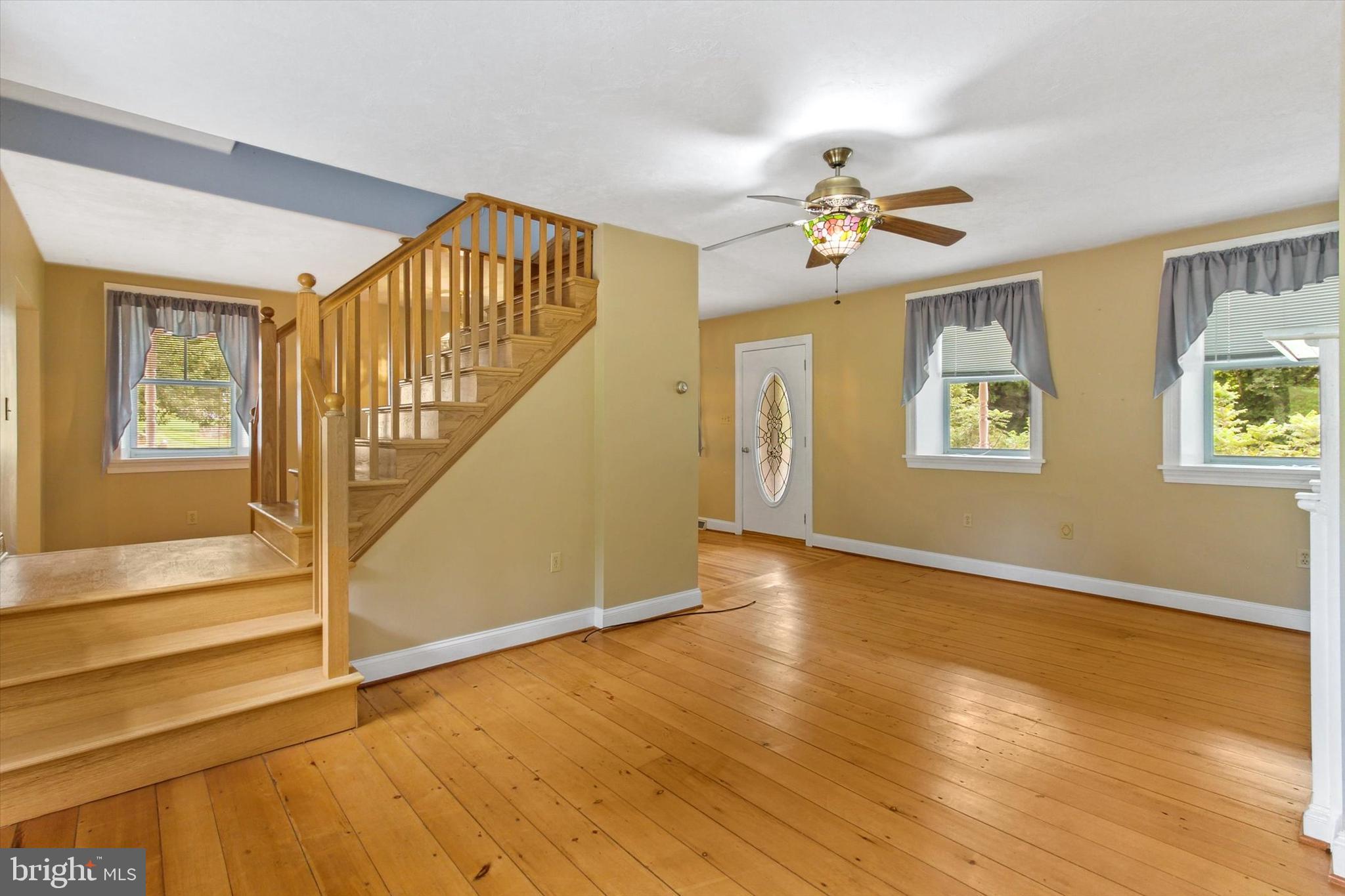 8219 Lehman Road Dallastown, PA 17313 - Photo 14 of 40 a view of an entryway with wooden floor and a ceiling fan