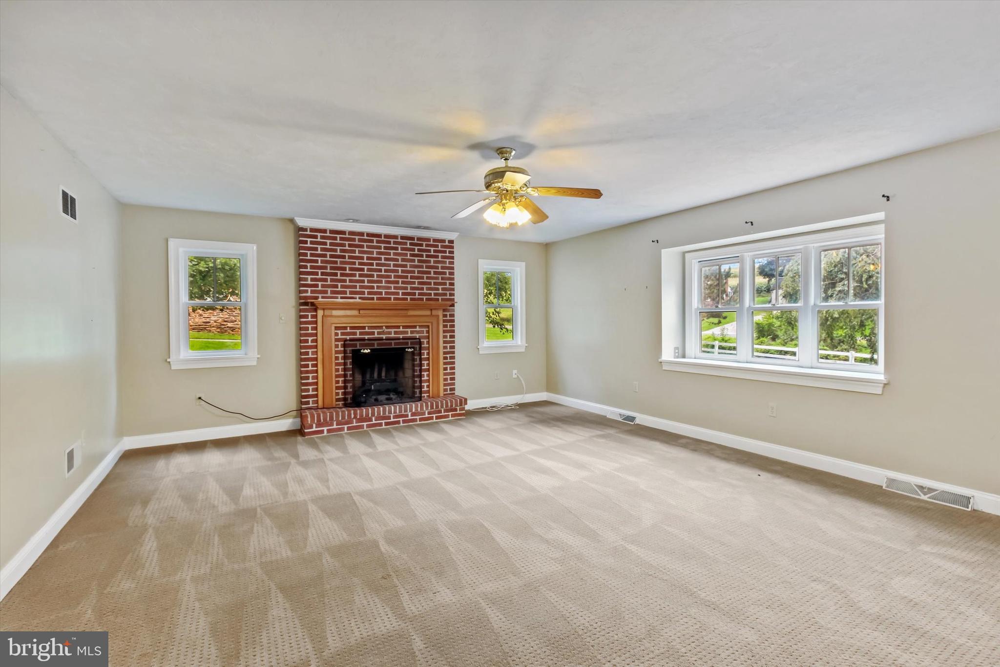8219 Lehman Road Dallastown, PA 17313 - Photo 21 of 40 an empty room with windows and fireplace