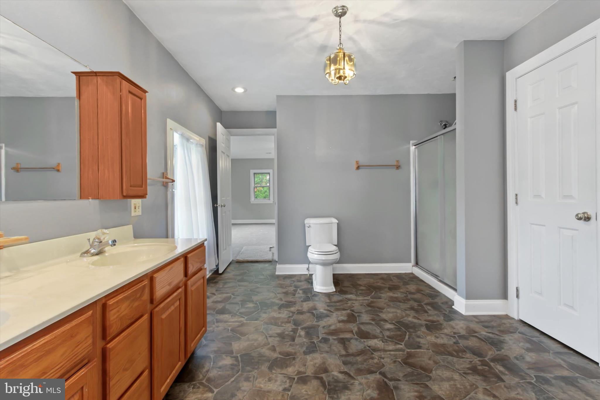 8219 Lehman Road Dallastown, PA 17313 - Photo 28 of 40 a bathroom with a sink a toilet and a mirror