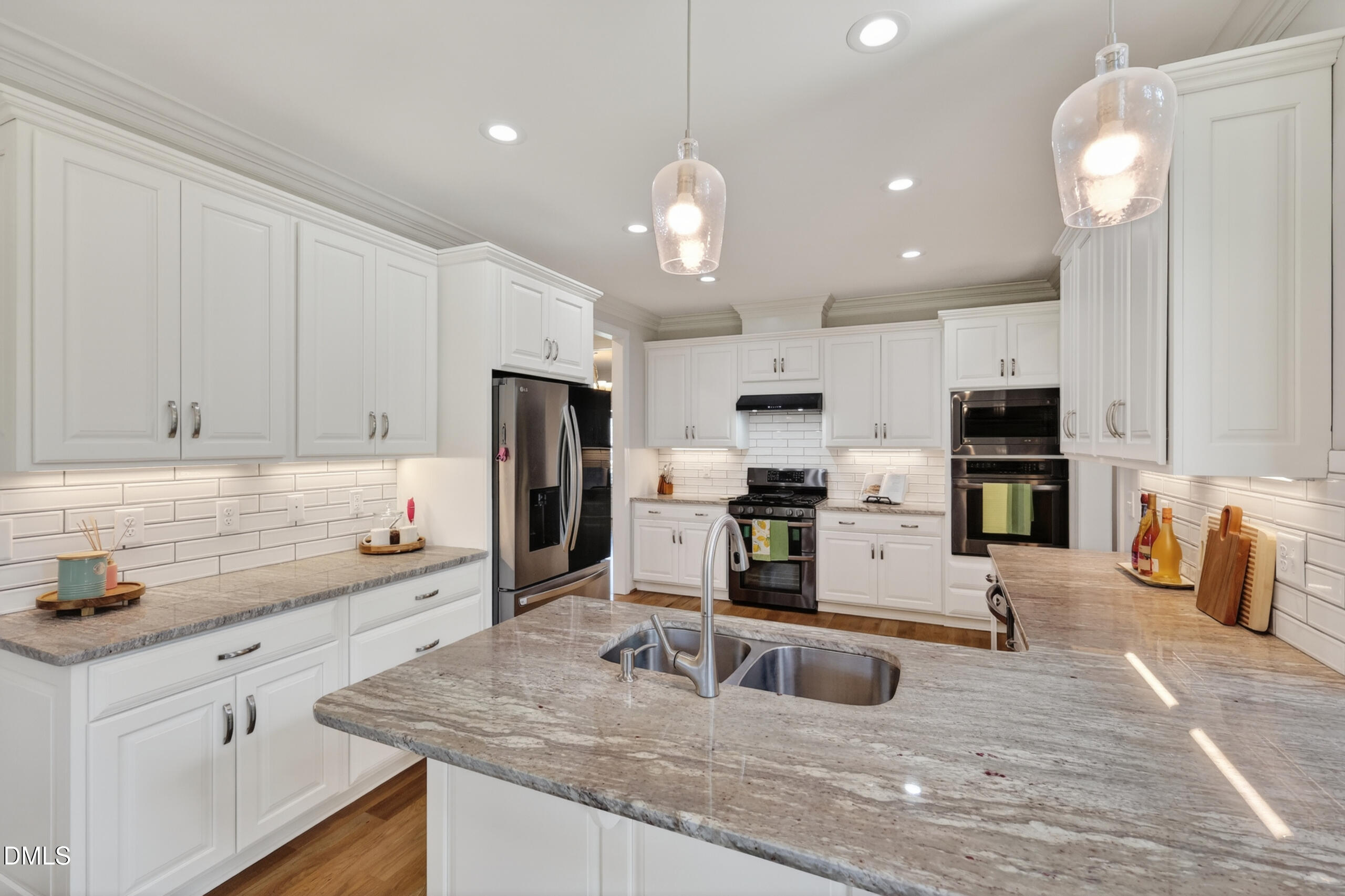 261 Character Drive Rolesville, NC 27571 - Photo 2 of 77 a kitchen with stainless steel appliances granite countertop a sink refrigerator and cabinets
