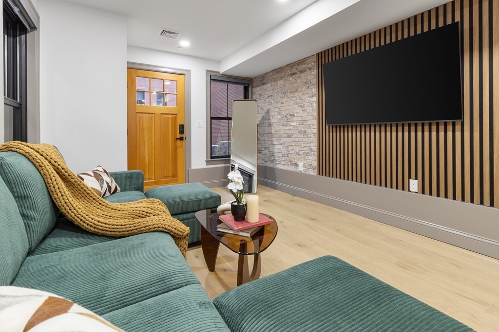 4 Snelling Place, Unit 4 Boston, MA 02113 - Photo 2 of 15 a living room with furniture and a flat screen tv