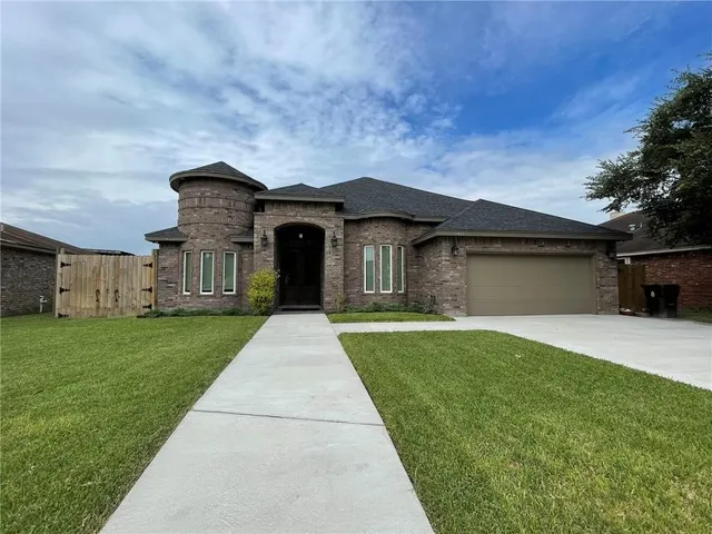 a front view of a house with a yard and garage