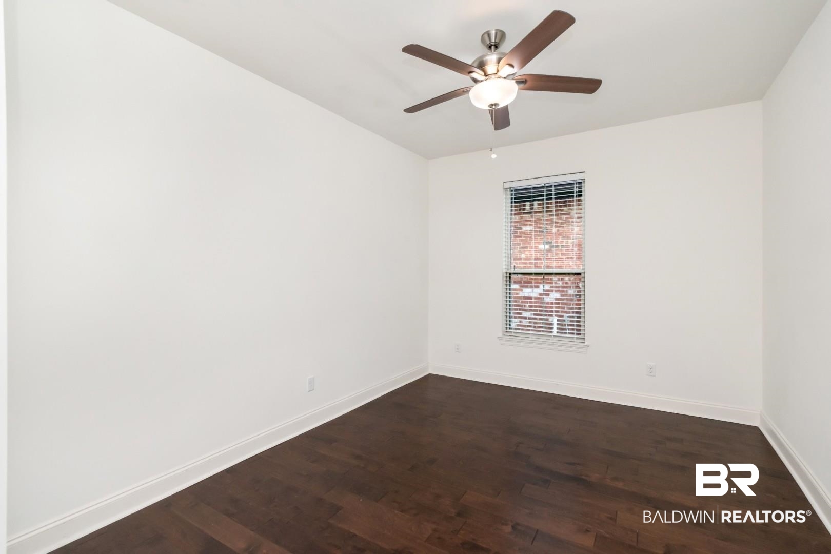 3528 Rue Royal Mobile, AL 36693 - Photo 32 of 53 Room featuring a ceiling fan with light fixture, wood-finish flooring, white baseboards, and a window with blinds. Not furnished