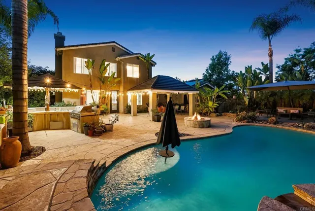 a large kitchen with stainless steel appliances lots of counter space and a sink