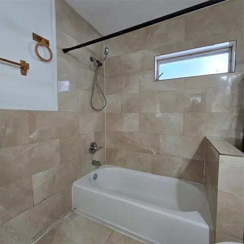 a bathroom with a bath tub with a shower