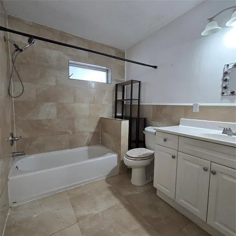 a bathroom with a toilet a sink and bathtub