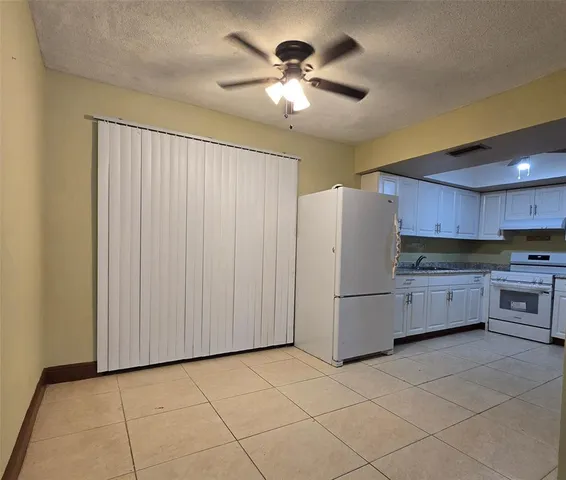 a kitchen with stainless steel appliances a refrigerator and a stove top oven