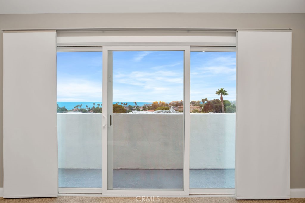 34511 Calle Monte Dana Point, CA 92624 - Photo 14 of 57 a view of a living room with a floor to ceiling window and an outdoor space