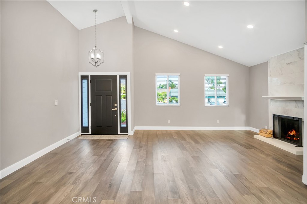 34511 Calle Monte Dana Point, CA 92624 - Photo 24 of 57 an empty room with wooden floor fireplace and windows