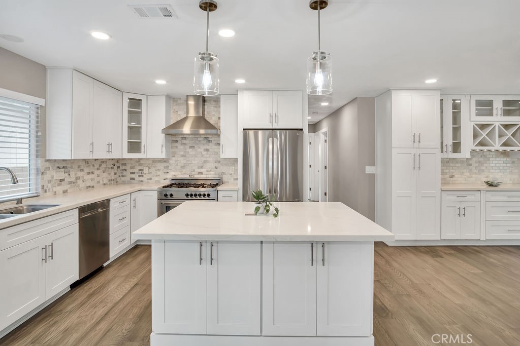 34511 Calle Monte Dana Point, CA 92624 - Photo 26 of 57 a large white kitchen with a kitchen island white cabinetry and stainless steel appliances