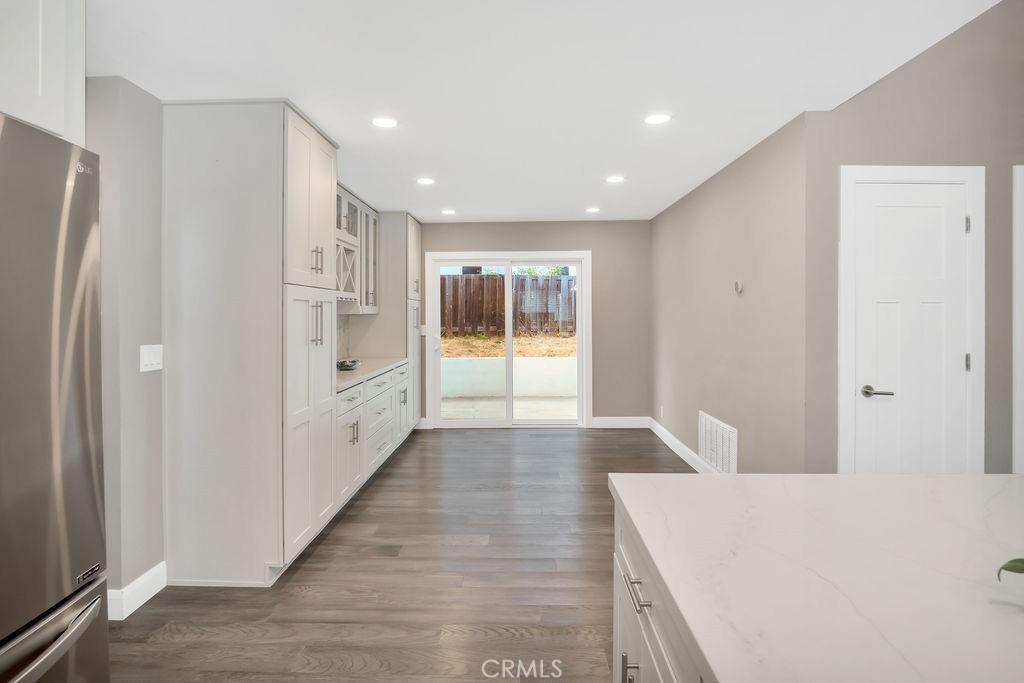 34511 Calle Monte Dana Point, CA 92624 - Photo 27 of 57 a hallway with white cabinets and wooden floor