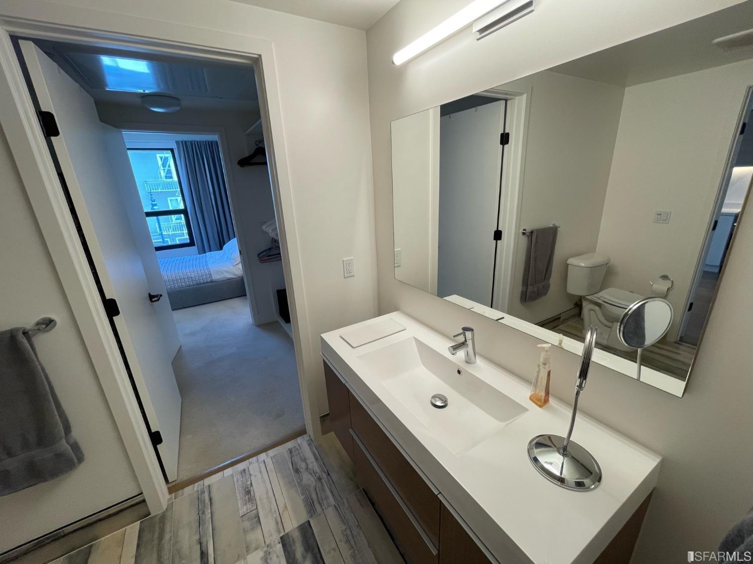 Larkin Street San Francisco, CA 94109 - Photo 14 of 24 a bathroom with a sink and a mirror