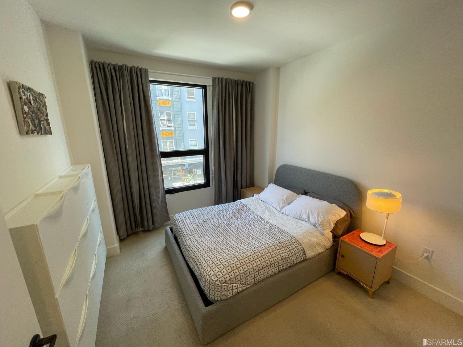 Larkin Street San Francisco, CA 94109 - Photo 17 of 24 a bedroom with a bed and window