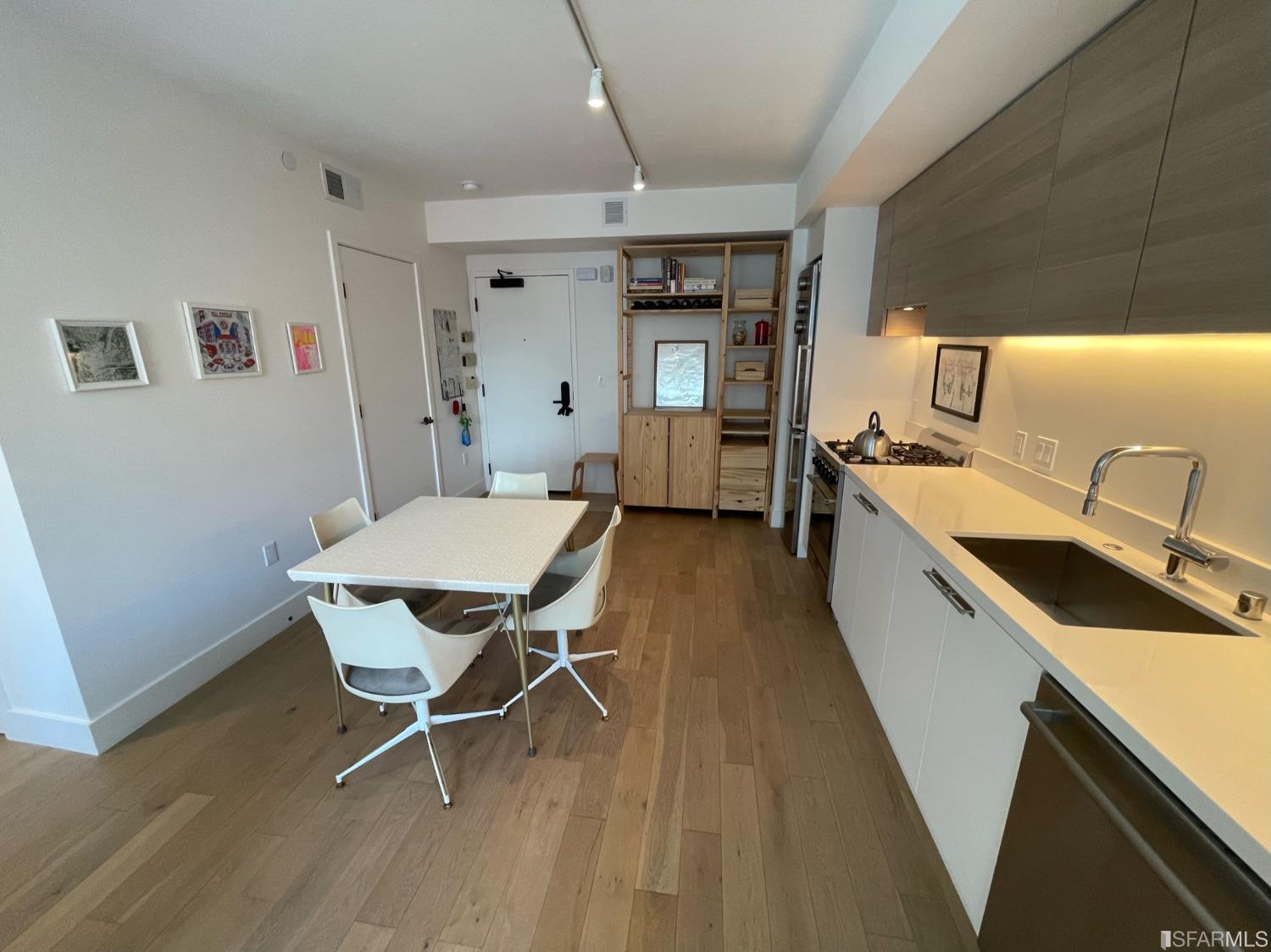 Larkin Street San Francisco, CA 94109 - Photo 4 of 24 a kitchen with a table chairs and wooden floor