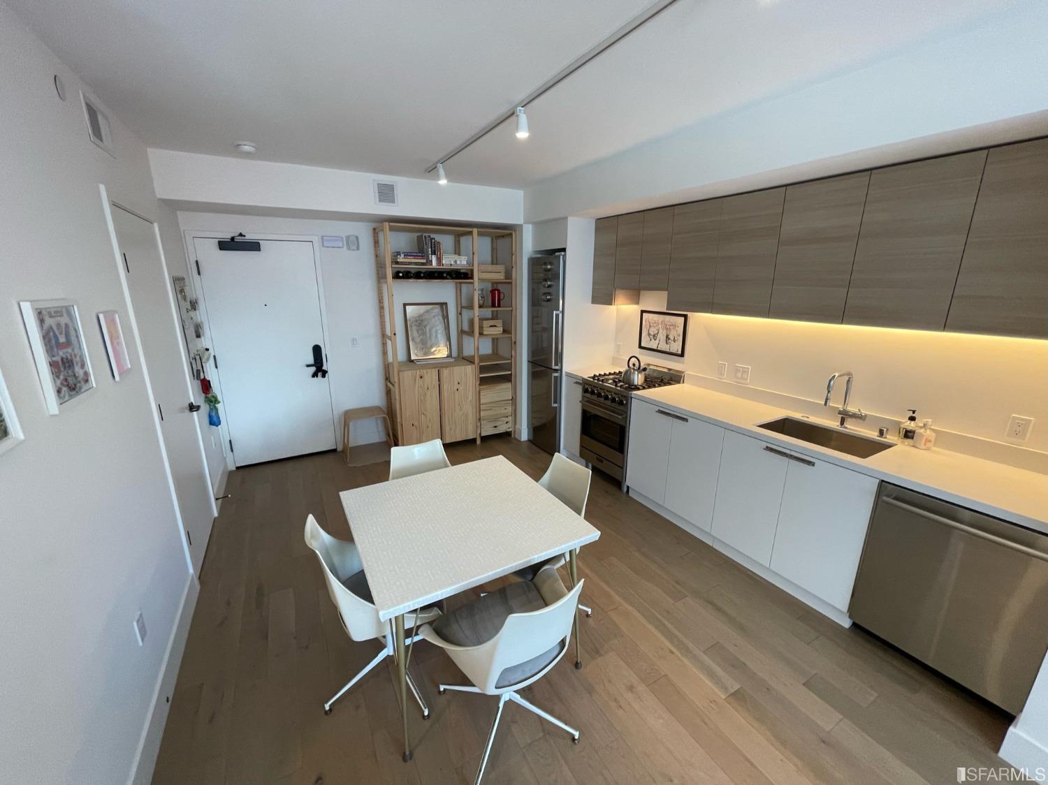 Larkin Street San Francisco, CA 94109 - Photo 5 of 24 a kitchen with granite countertop a sink stove and refrigerator