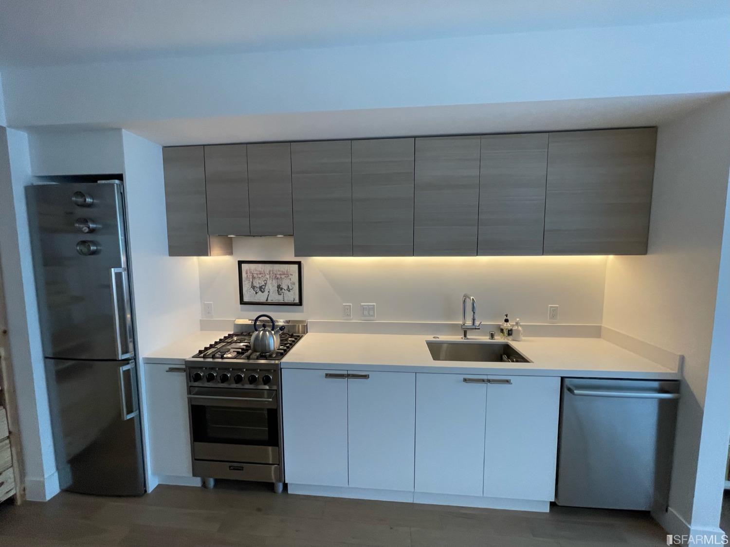 Larkin Street San Francisco, CA 94109 - Photo 6 of 24 a kitchen with granite countertop a sink cabinets and stainless steel appliances