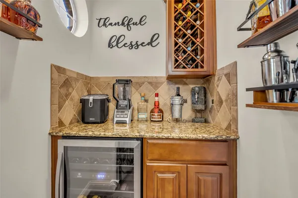 a kitchen with granite countertop a sink a dining table and chairs