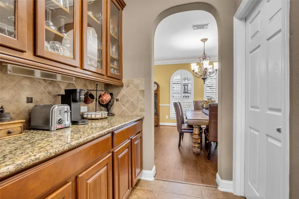 a view of a dining room with furniture and chandelier
