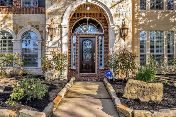 a view of a hallway with wooden floor and windows