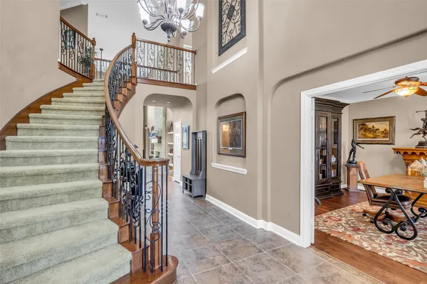 a view of an entryway and hall with a front door