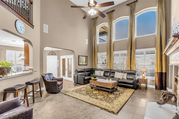 a living room with furniture large window and fireplace