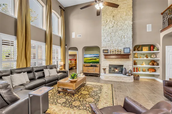 a living room with furniture and a chandelier