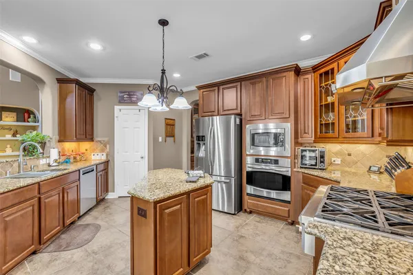 a kitchen with granite countertop a stove and a sink