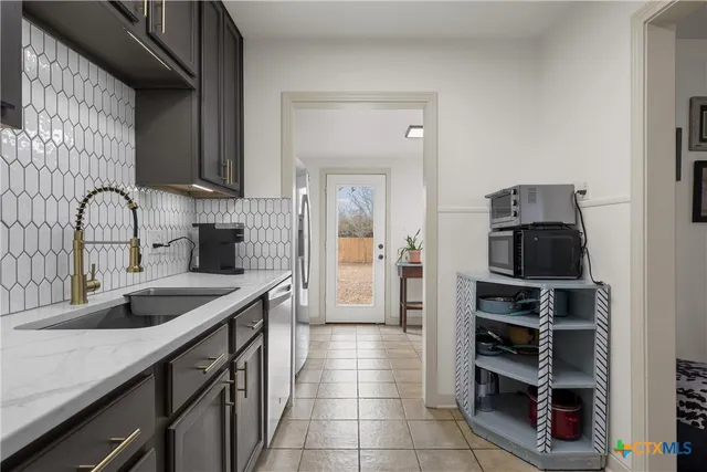 a kitchen with a sink and cabinets