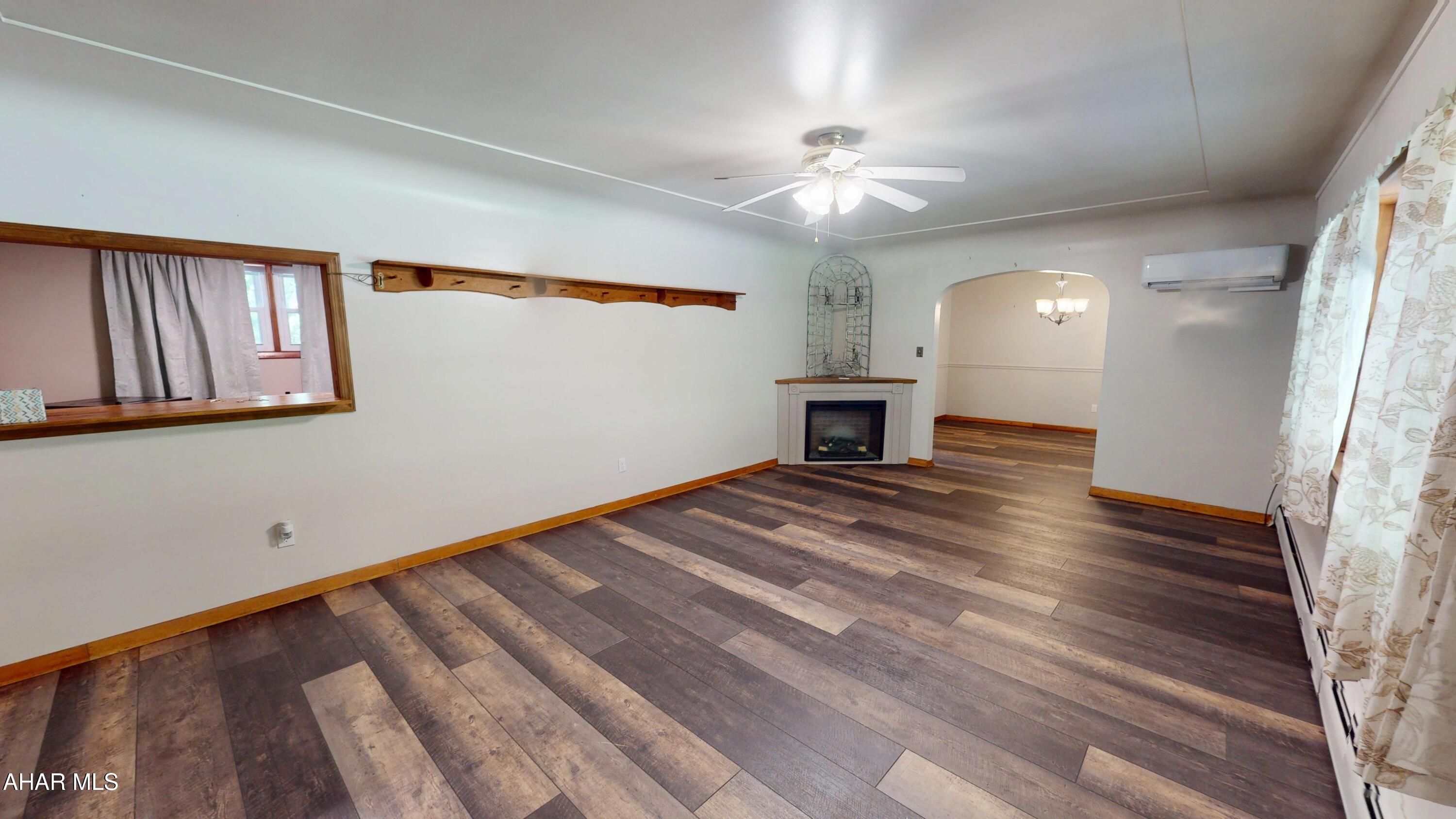 871 Decker Hollow Road Tyrone, PA 16686 - Photo 11 of 35 wooden floor in an empty room with a window