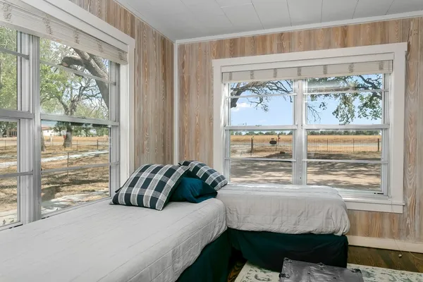 a bedroom with a bed and a window