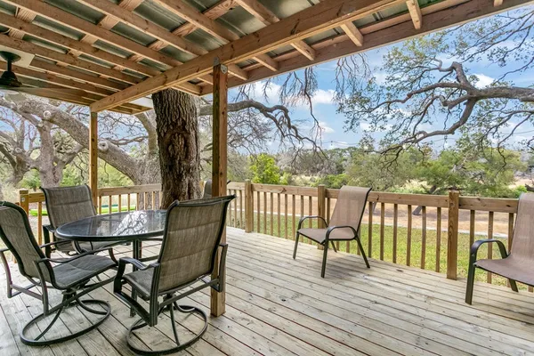 a view of a chairs and table on the deck