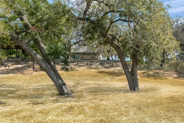 a view of yard with swimming pool and trees