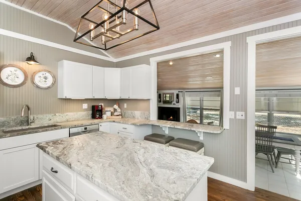 a kitchen with a sink a stove and cabinets