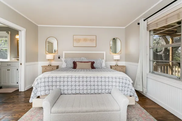 a bedroom with a large bed and a window