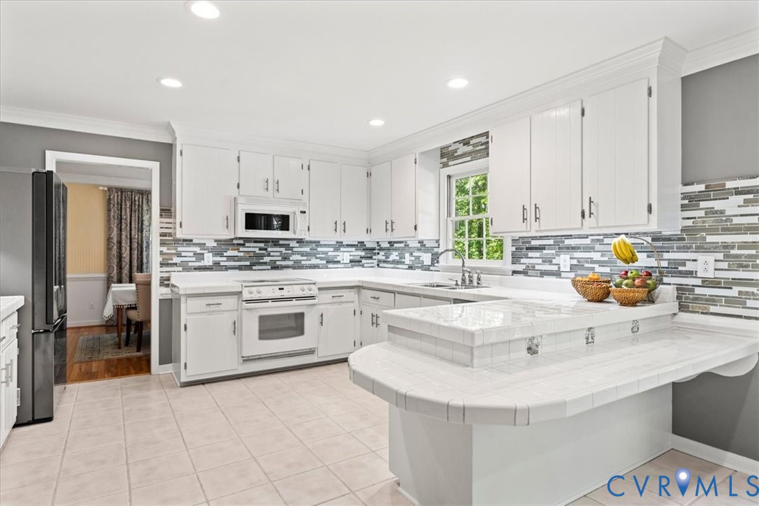 1113 Royal Ridge Road Midlothian, VA 23114 - Photo 27 of 55 Bright kitchen featuring white cabinetry, a mosaic