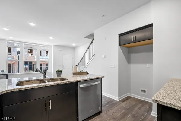 a kitchen with stainless steel appliances granite countertop a sink and a stove