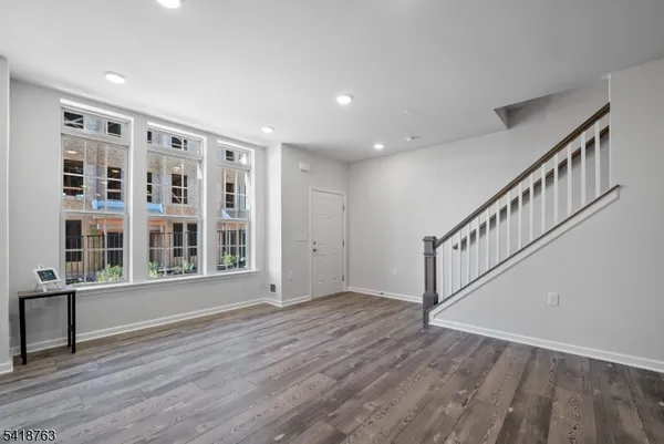 a view of an entryway with wooden floor