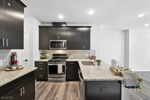a kitchen with a sink stove and microwave