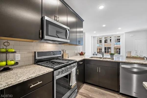 a kitchen with a sink stainless steel appliances and cabinets