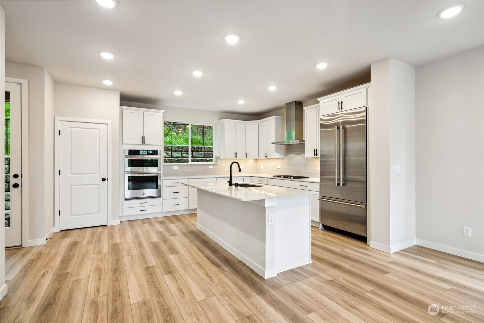 4010 Aberdeen Place Northeast, Unit 31 Renton, WA 98056 - Photo 5 of 35 a large kitchen with kitchen island a sink stainless steel appliances and cabinets