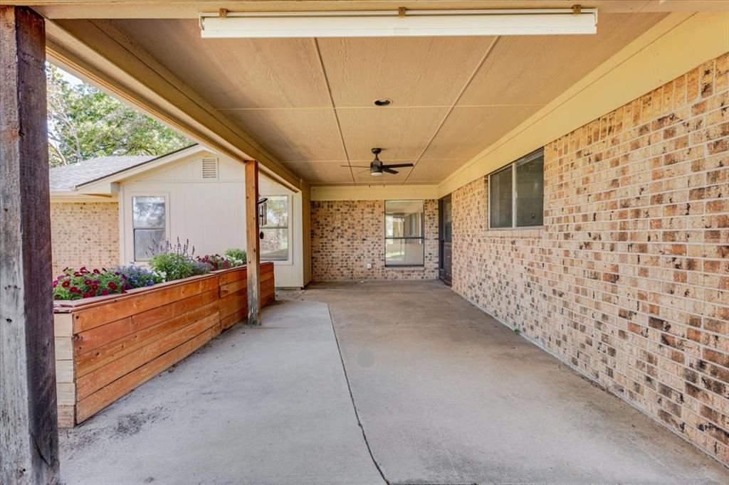 8105 Ravenswood Road Granbury, TX 76049 - Photo 17 of 28 Covered patio with brick siding, concrete flooring, recessed lighting, and a ceiling fan