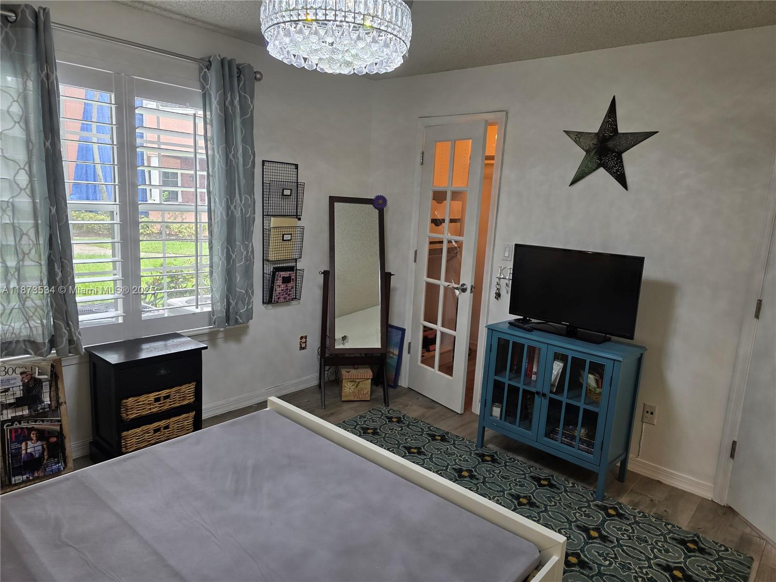 1365 Crystal Way, Unit G Delray Beach, FL 33444 - Photo 11 of 30 a living room with furniture a flat screen tv and a window