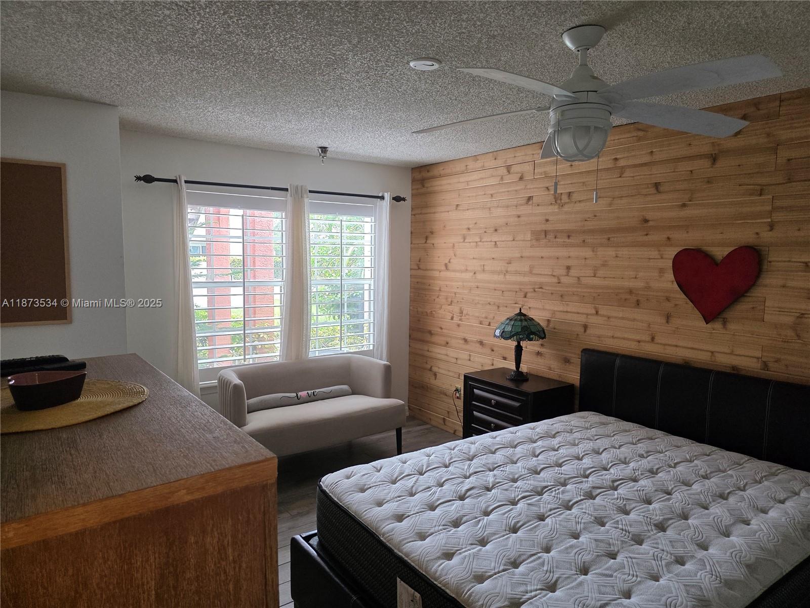 1365 Crystal Way, Unit G Delray Beach, FL 33444 - Photo 18 of 30 a bedroom with a bed and a dresser