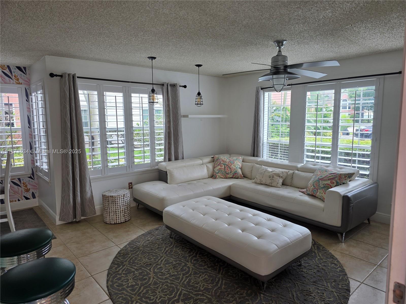 1365 Crystal Way, Unit G Delray Beach, FL 33444 - Photo 2 of 30 a living room with furniture and a large window