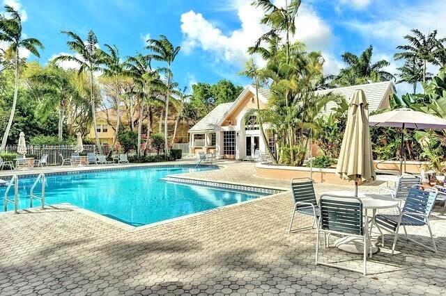 1365 Crystal Way, Unit G Delray Beach, FL 33444 - Photo 29 of 30 a view of house with swimming pool and chair