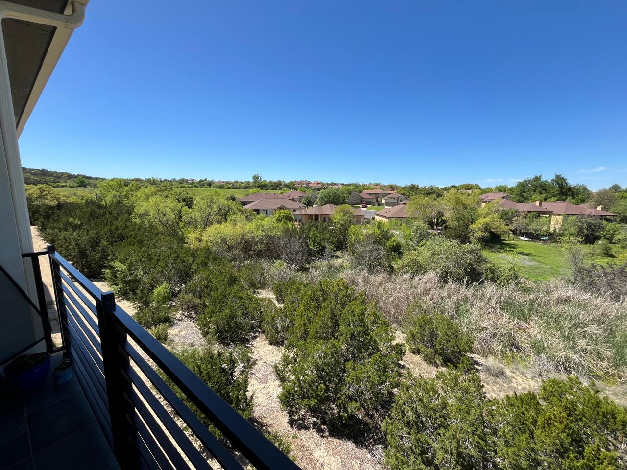 2050 Lohmans Spur Road, Unit 1302 Lakeway, TX 78734 - Photo 11 of 18 a view of a city from a balcony with outdoor seating