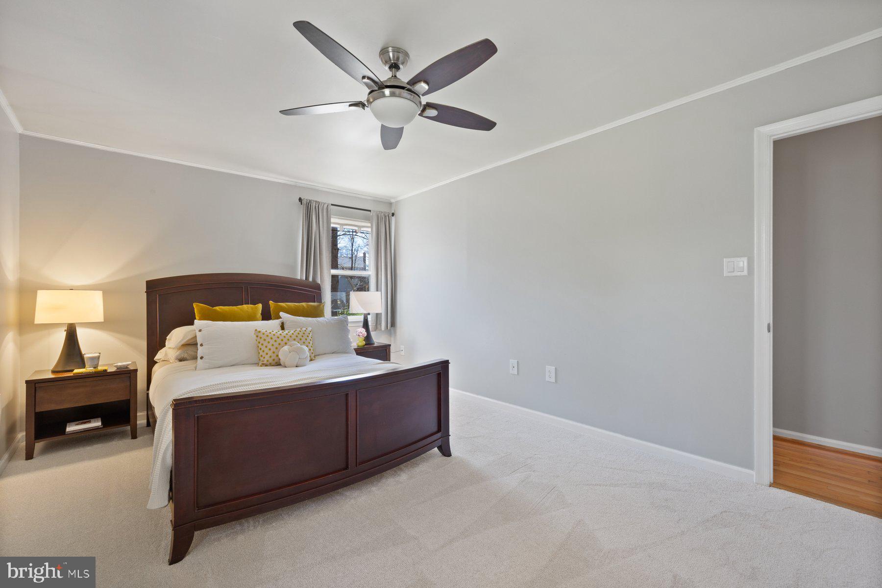 9008 Arley Drive Springfield, VA 22153 - Photo 17 of 40 a spacious bedroom with a bed and a ceiling fan